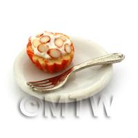 Miniature Chopped Almond Cupcake In An Orange Cup On A Plate With A Fork