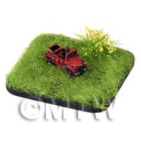 a red painted Gaz 68 Field Car on grass