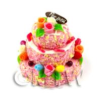 1/12th scale - Miniature 3 Tier Pink Iced Celebration Cake topped with Fondant Flowers 